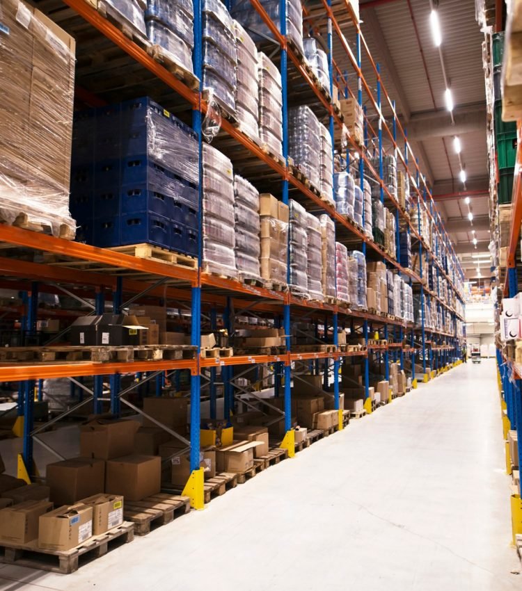 interior-large-distribution-warehouse-with-shelves-stacked-with-palettes-goods-ready-market